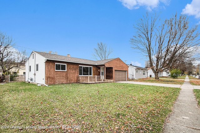 single story home with a garage and a front lawn