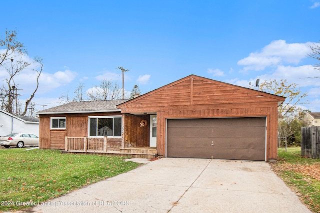 single story home featuring covered porch, a garage, and a front yard