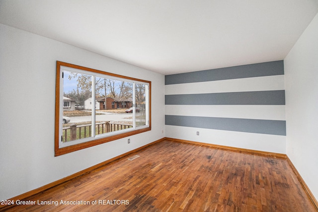 unfurnished room featuring wood-type flooring