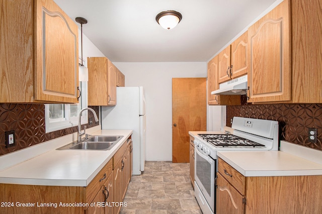 kitchen featuring pendant lighting, decorative backsplash, sink, and white appliances