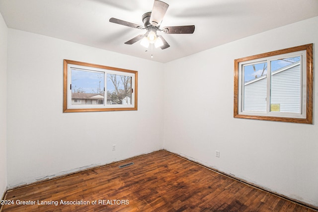 unfurnished room featuring a wealth of natural light, ceiling fan, and hardwood / wood-style flooring