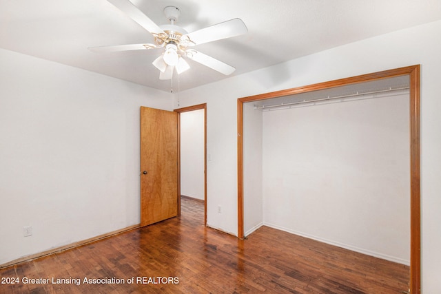 unfurnished bedroom featuring ceiling fan, dark hardwood / wood-style floors, and a closet