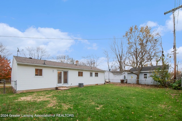 rear view of house featuring a yard