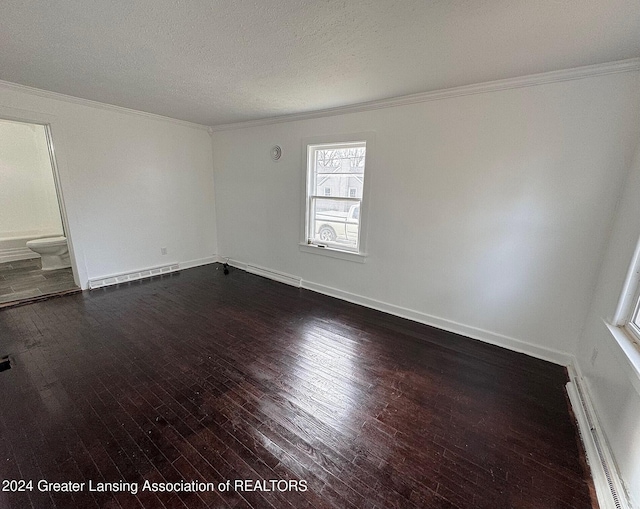 unfurnished room with dark hardwood / wood-style floors, a textured ceiling, a baseboard heating unit, and crown molding