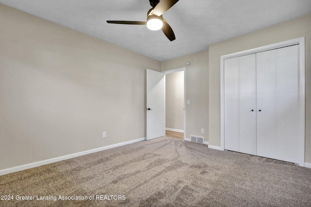 unfurnished bedroom featuring a closet, ceiling fan, and carpet floors