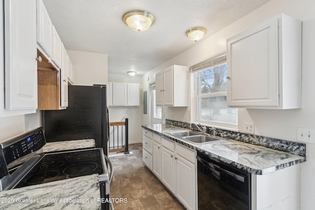 kitchen with black appliances, a sink, and white cabinetry