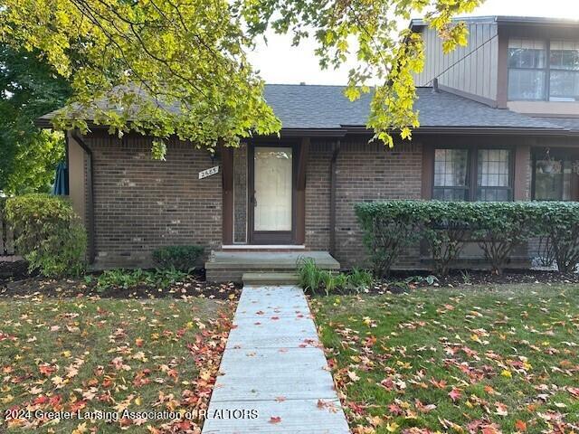 doorway to property featuring a yard