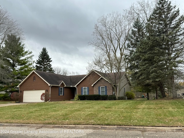 view of front of house with a garage and a front yard