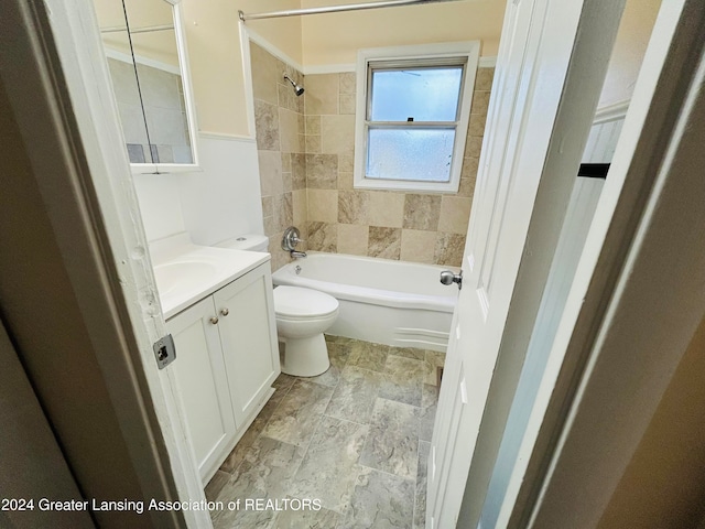 full bathroom with vanity, toilet, and tiled shower / bath