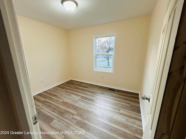 unfurnished room with light hardwood / wood-style flooring