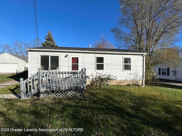 view of front of house with a front yard and a deck