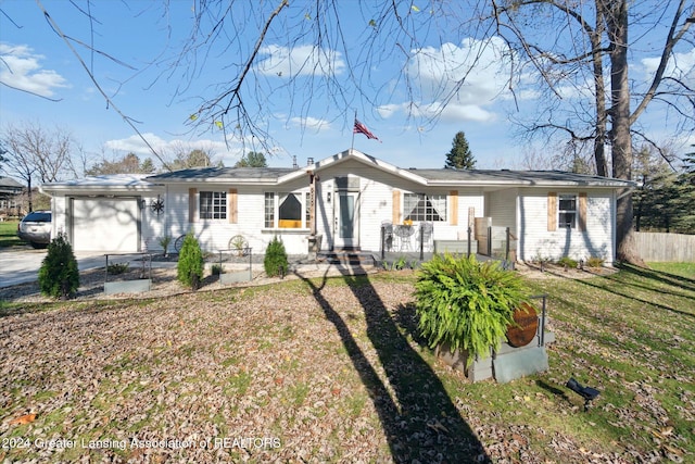 single story home featuring a garage and a front yard