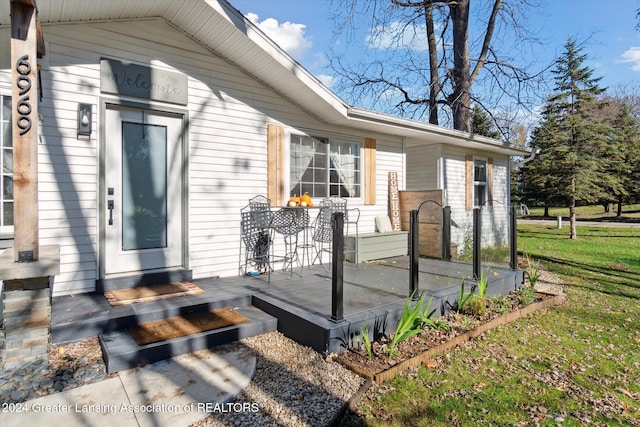 entrance to property with elevator and a yard