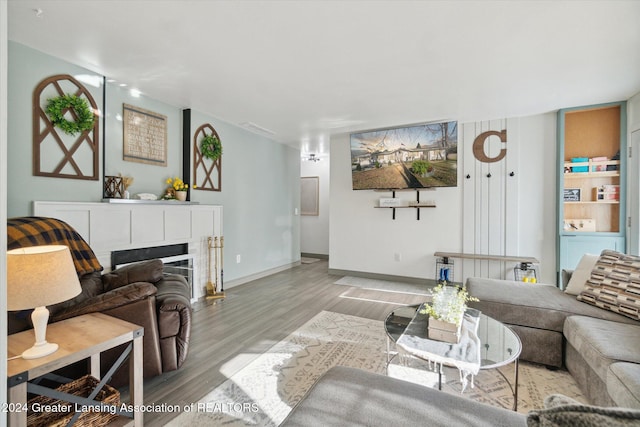 living room with light wood-type flooring and washer / dryer