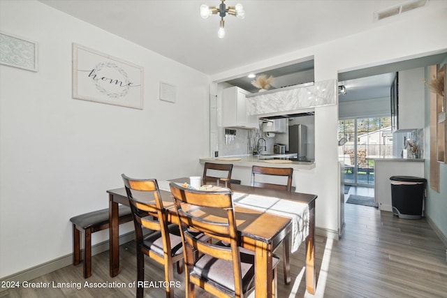 dining space with dark hardwood / wood-style flooring and sink