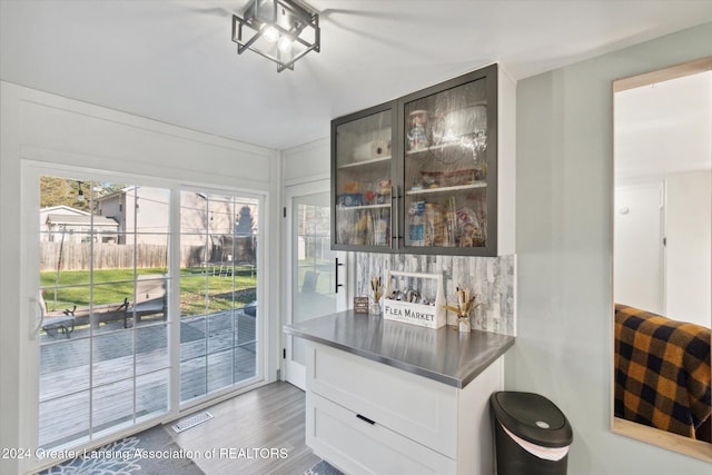 bar featuring white cabinets and wood-type flooring