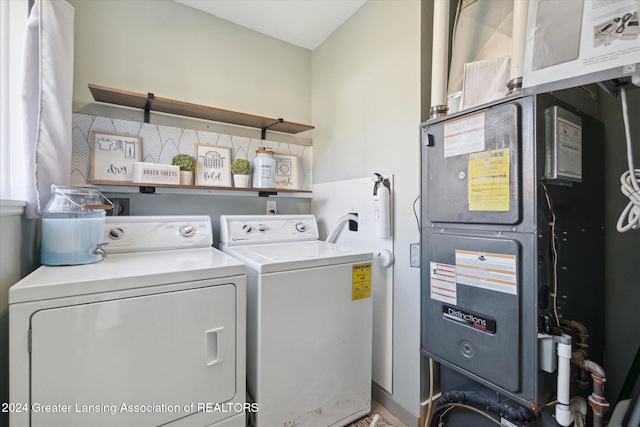 laundry area with washing machine and dryer and heating unit