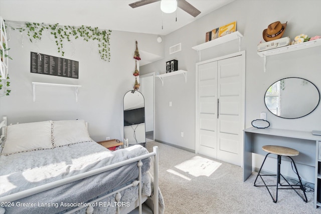 carpeted bedroom featuring ceiling fan and a closet