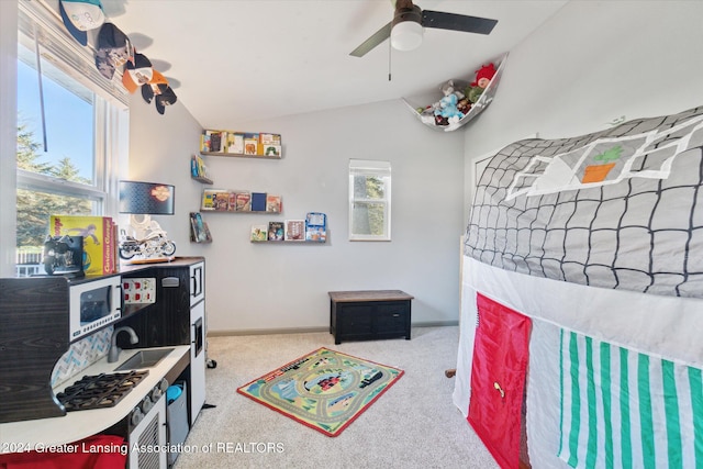 bedroom featuring ceiling fan, light carpet, and vaulted ceiling