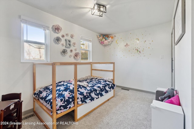 carpeted bedroom featuring multiple windows