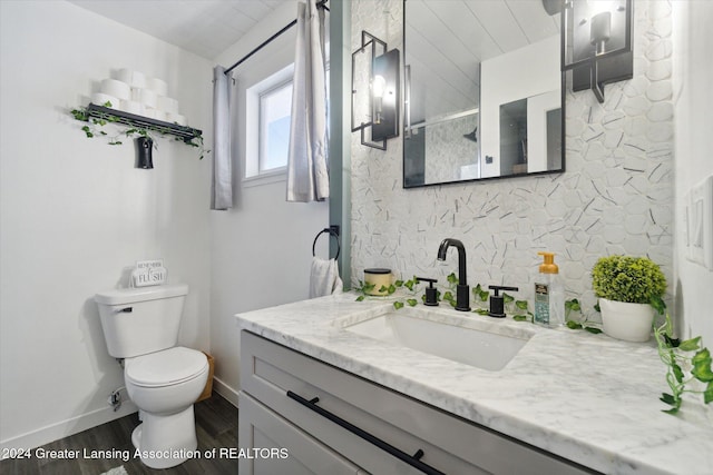 bathroom featuring hardwood / wood-style flooring, vanity, and toilet