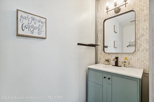 bathroom with decorative backsplash and vanity