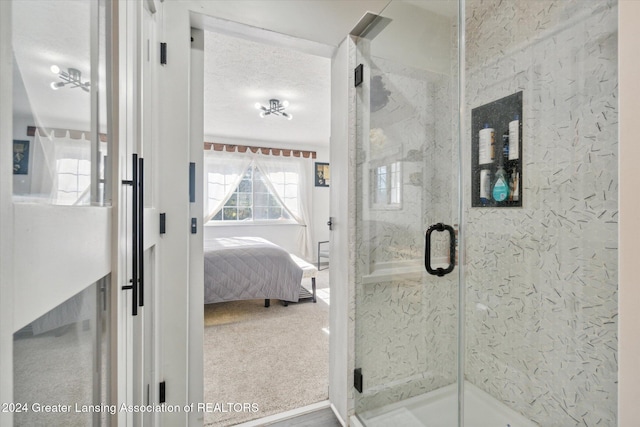 bathroom with an enclosed shower and a textured ceiling