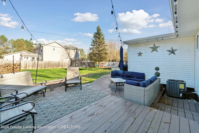 wooden deck with an outdoor living space, a lawn, central AC, and a trampoline