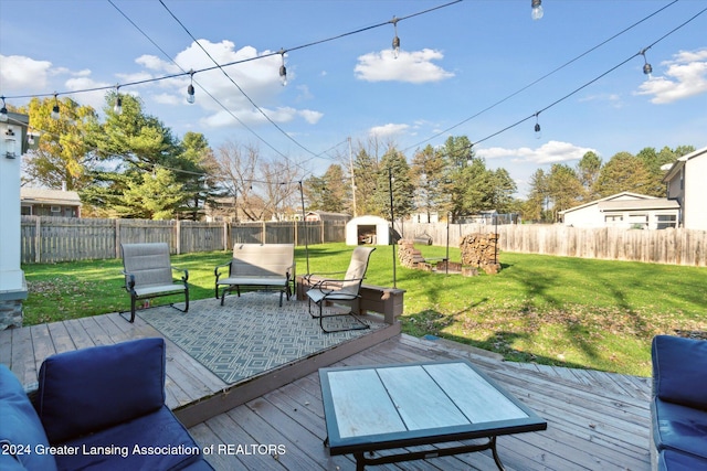 wooden deck featuring a yard and a storage shed