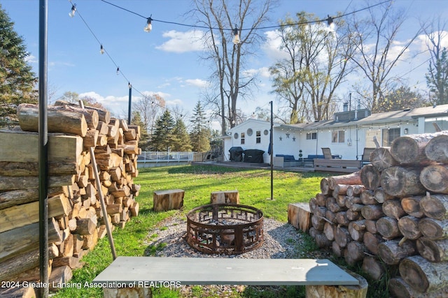 view of yard with an outdoor fire pit