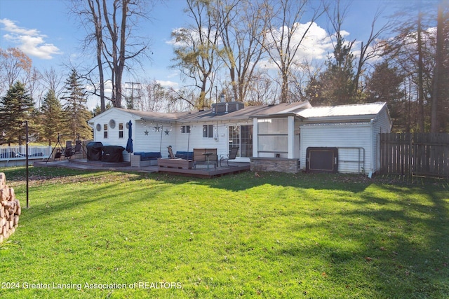 view of front of house featuring a front lawn and a wooden deck