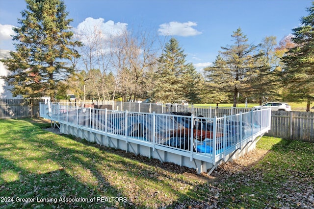 view of pool with a yard