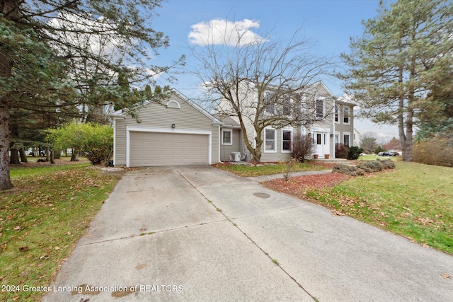 view of front of property featuring a front yard and a garage