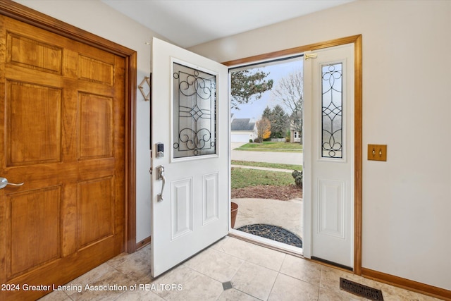 entryway with light tile patterned floors