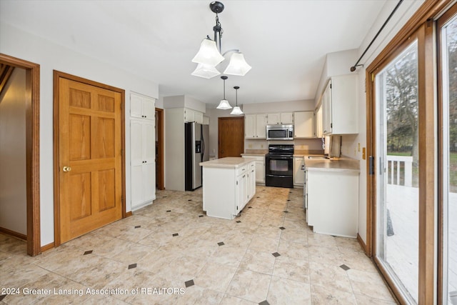 kitchen featuring pendant lighting, a kitchen island, white cabinets, and stainless steel appliances