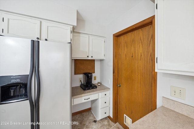 kitchen with white cabinets and white refrigerator with ice dispenser