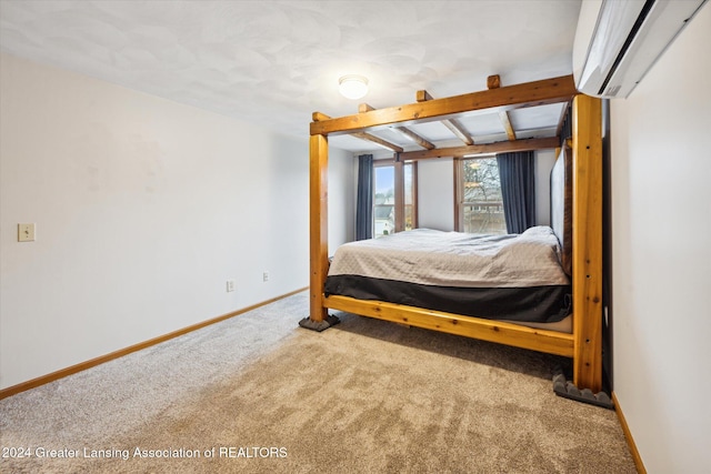 bedroom with beam ceiling, carpet floors, and a wall unit AC