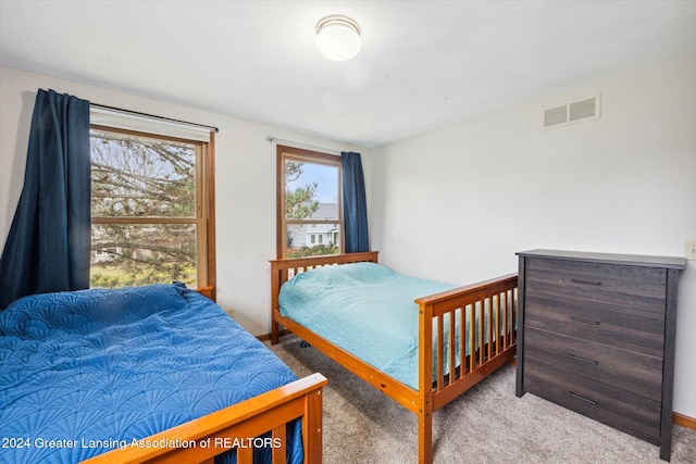 bedroom featuring light carpet