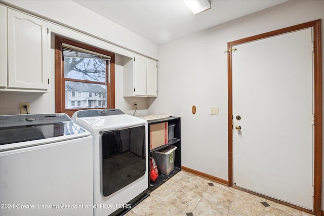 laundry area with cabinets and washing machine and clothes dryer