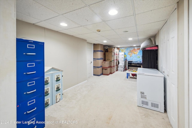 interior space featuring carpet and a drop ceiling