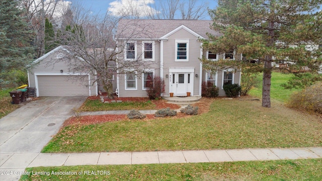 view of front of house with a front yard and a garage