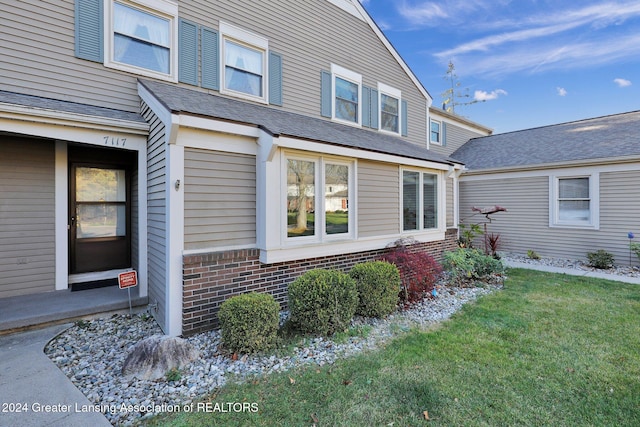 view of home's exterior with a lawn