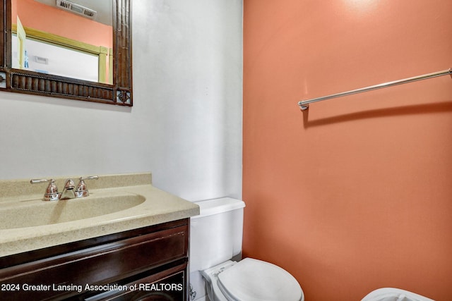 bathroom with vanity and toilet