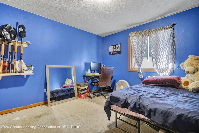 bedroom with concrete flooring and a textured ceiling