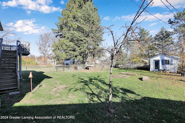 view of yard with an outdoor structure and a deck