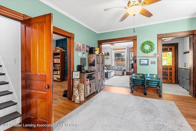 interior space featuring light wood-type flooring and crown molding