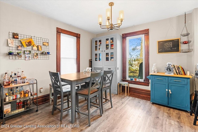 dining room featuring hardwood / wood-style flooring and a chandelier