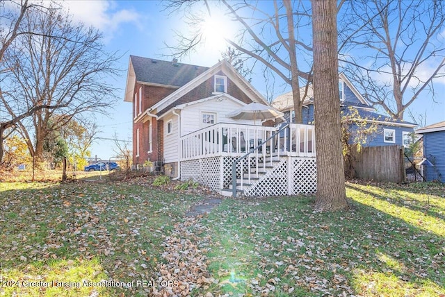 exterior space featuring a wooden deck and a yard