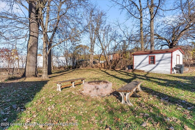 view of yard with a storage unit and a fire pit