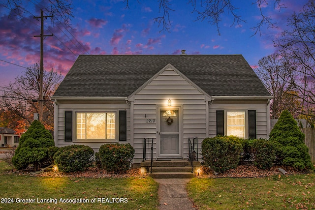 bungalow-style house featuring a lawn